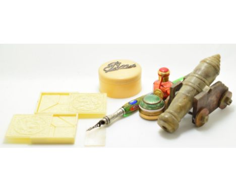 A 19thC Chinese carved soapstone cannon, length 12cm, Victorian glass dip pen with ornate nib, Tangram puzzles, pin container