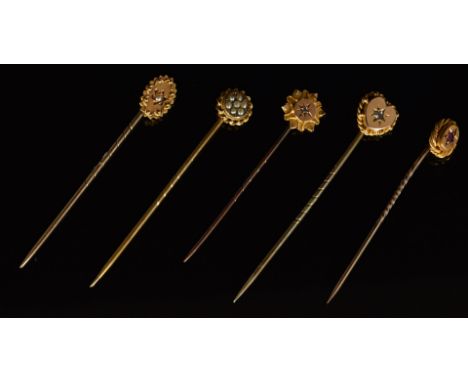 Three 9ct gold stick pins set with paste, pearls and a diamond (2.7g) and two 15ct gold stick pins set with a ruby and pearl 