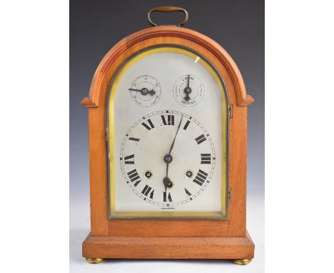 19thC style bracket or mantel clock with arched silvered dial also having slow fast and chime silent controls, the three trai