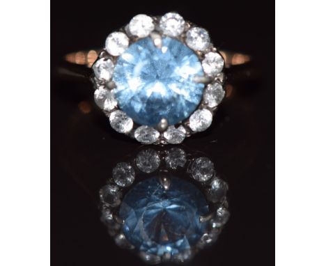 A 9ct gold ring set with a topaz surrounded by white sapphires, 3.5g, size M