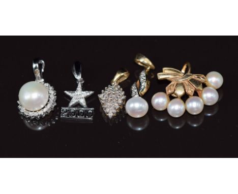 A 14k white gold pendant set with a pearl and diamonds (1.5g), a 9ct gold pendant set with diamonds, two further 9ct gold pen