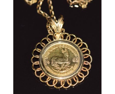 A yellow metal pendant set with a 1982 1/10 Krugerrand, on 9ct gold chain, 7.5g