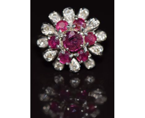 An 18ct white gold ring set with rubies and diamonds in a floral cluster, 5.1g, size I