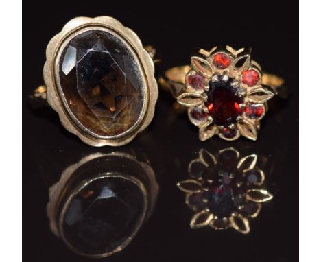 Two 9ct gold rings, one set with garnets and one a smoky quartz, 6.9g, size K