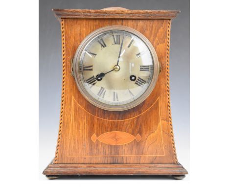 Arts &amp; Crafts or Art Nouveau oak and inlaid mantel clock, with domed top and silvered dial, the two train movement striki