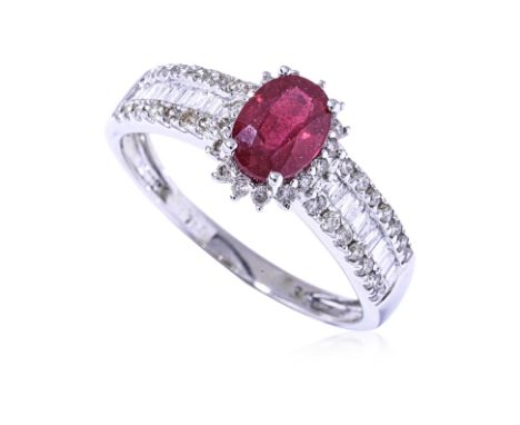 A RED STONE AND DIAMOND RING
Featuring a red stone, likely a glassed filled ruby, mounted in a white gold setting marked '750