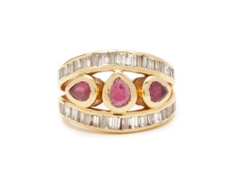 A GOLD DIAMOND AND RUBY RING
.Of openwork design set with three rubies to the centre within baguette cut diamond borders
7g
C