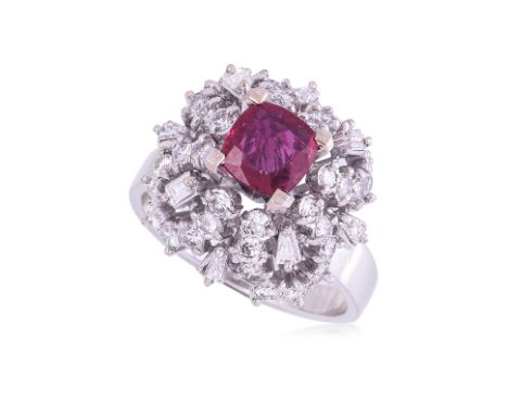 A RUBY AND DIAMOND RING Featuring a cushion cut ruby weighing approximately 0.90 Cts, mounted in a white gold setting marked 