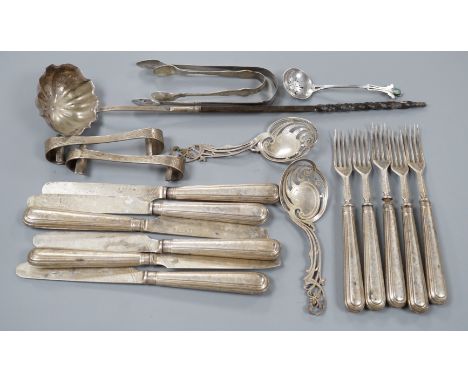 A pair of Victorian silver scrolling knife rests, George Adams, London, 1859, 10.4cm, a pair of pierced silver spoons, two pa