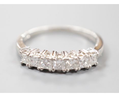 A modern platinum and seven stone princess cut diamond set half hoop ring, size M/N, gross weight 4 grams, total diamond weig