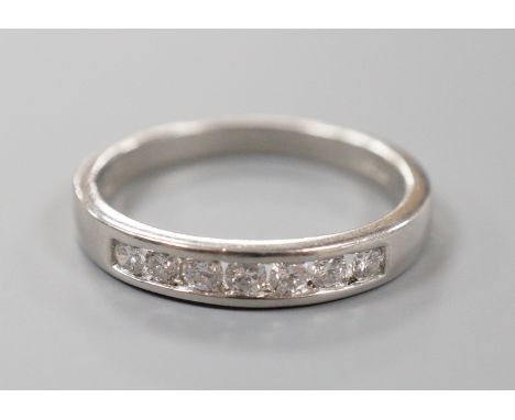 A modern platinum and channel set seven stone half hoop ring, size P, gross weight 5.1 grams, total diamond weight approx. 0.