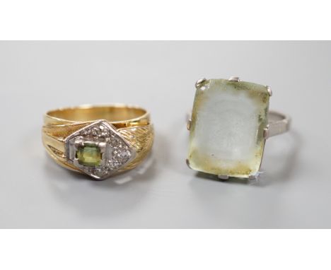 An 18ct white metal and paste set ring, gross 6.1 grams, and one other continental diamond and tourmaline? set cluster ring, 