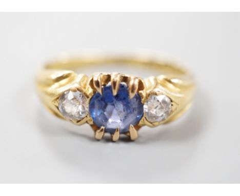 A late Victorian 18ct gold, sapphire and diamond set three stone ring, size I, gross weight 3 grams.