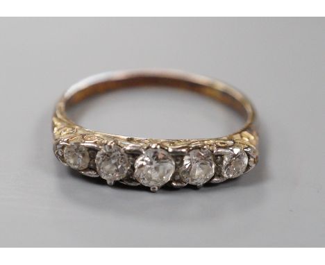 An early 20th century 18ct and graduated five stone diamond set half hoop ring, size P/Q, gross weight 2.7 grams.