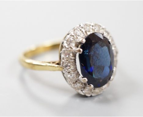 A modern 18ct gold, sapphire and diamond set oval cluster ring, size M, gross weight 4.9 grams.