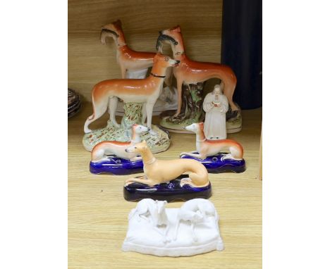 A Staffordshire pottery figure of John Wesley, six Staffordshire pottery models of hounds, and a white bisque group of two ho