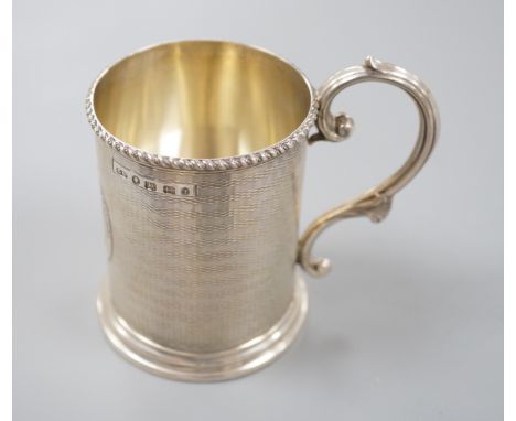 A Victorian engine turned silver christening mug, with engraved inscription, George Unite, Birmingham, 1868, 86mm.