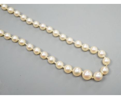 A single strand graduated cultured pearl necklace, with four stone diamond set white metal clasp, 50cm, gross weight 14.4 gra