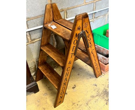 A pair of vintage style walnut folding cellar steps painted with champagne brands