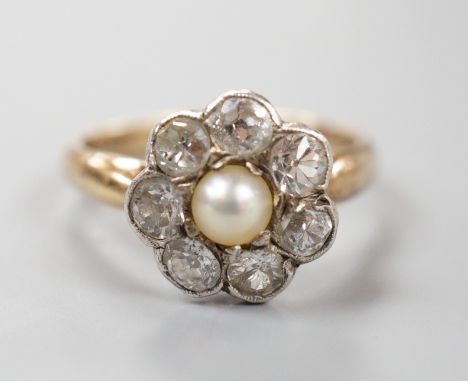 A late Victorian yellow metal, single stone split pearl and seven stone diamond set circular cluster ring, size I, gross weig