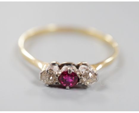 An 18ct, ruby and diamond set three stone ring, size V, gross weight 1.7 grams.