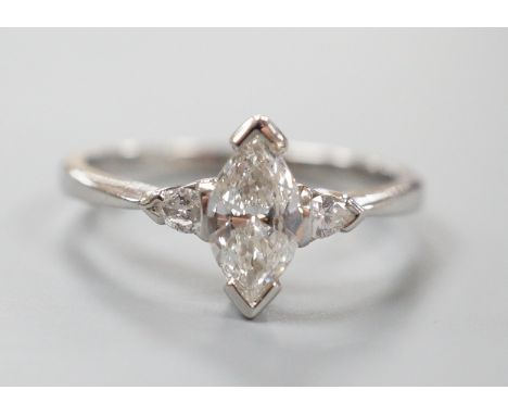 A modern platinum and single stone marquise diamond set ring, with two stone pear cut diamond set shoulders, size M, gross we