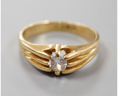 A late Victorian 18ct gold and claw set solitaire diamond ring, size, S/T, gross 6.3 grams.