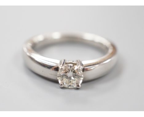 A modern platinum and solitaire diamond ring, size M, gross weight 8.7 grams, the diamond weighing approx. 0.55ct.