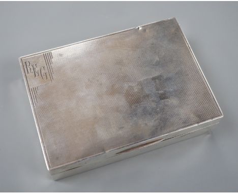 A George V engine turned silver rectangular cigarette box, Mappin &amp; Webb, London, 1933, 12.8cm.