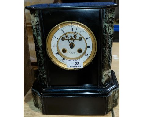 A 19th century mantel clock with visible escapement and French striking movement in black and variegated marble architectural