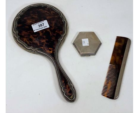 A hallmarked silver and tortoiseshell hand mirror and comb, Birmingham 1922; a hallmarked silver compact, octagonal shaped, e