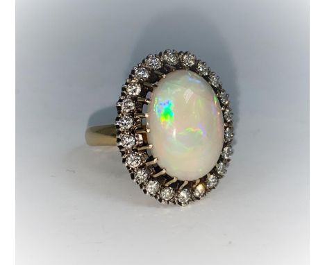 An large oval opal and diamond dress ring stamped 18 ct, 22 diamonds, size Q, gross