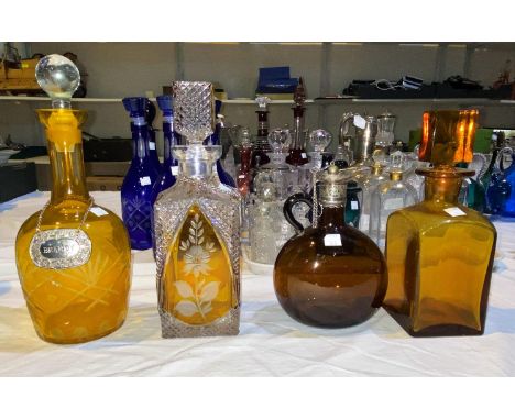 A square decanter in amber overlaid glass; a similar decanter; 2 others 