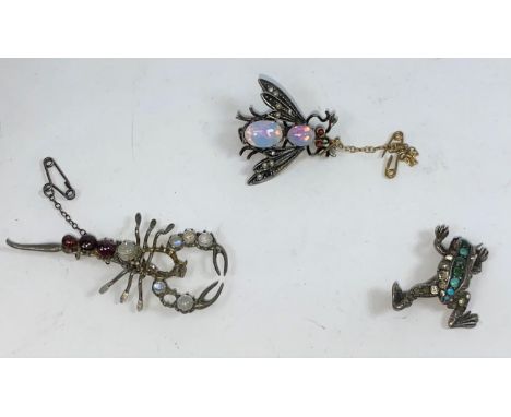 Three novelty brooches set with various stones - a fly with opal effect body and red eyes, a scorpion with moonstone style se