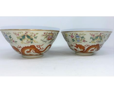 A pair of Chinese bowls finely decorated with dragons, vases etc, light blue interior and bases, with seal mark, (one with ha