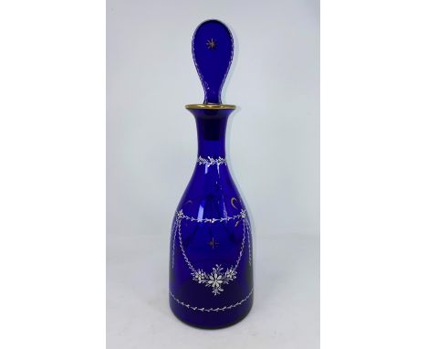 A Georgian Bristol blue decanter, mallet shaped and decorated with swags and garlands in white enamel