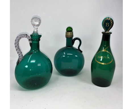 Two 19th century green glass claret jugs; a green 'Brandy' decanter; a turquoise glass wine jug 