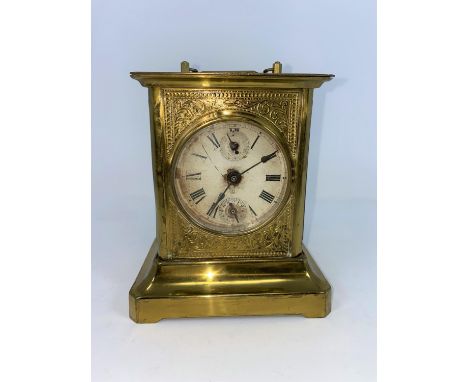 A 19th century American brass mantel / alarm clock in the style of a carriage clock 