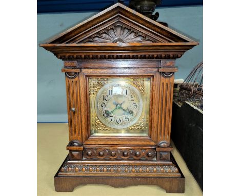 An Edwardian mantel clock in architectural oak case, with strike 