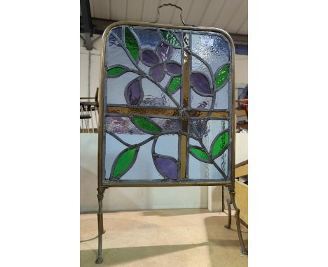 A coloured and leaded brass firescreen 
