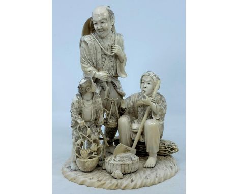 A finely carved late 19th / early 20th century Japanese ivory family group of fisher folk, the man holding a fish on a basket