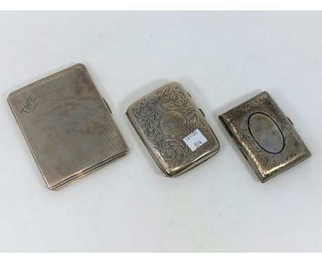 Three hallmarked silver cigarette cases, one engine turned and two chased, Birmingham 1941, 119 &amp; 1921, 10 oz