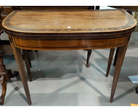 An early 19th century mahogany card table with inlaid decoration to the 'D' end fold-over top, on square tapering legs 