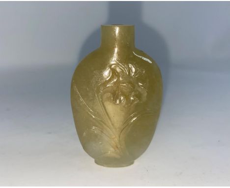 A Chinese carved hardstone snuff bottle with figures and scenery, 7cm; another jade coloured hard stone snuff bottle, height 