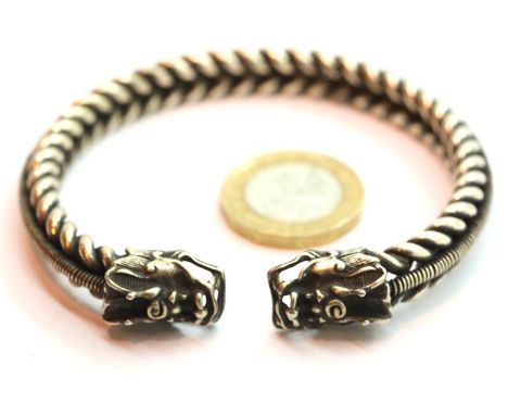 Twisted white metal bangle with dragon head finials. P&amp;P Group 1 (£14+VAT for the first lot and £1+VAT for subsequent lot