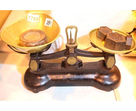 Cast iron and brass Libre Scale Co scales and four weights. P&amp;P Group 3 (£25+VAT for the first lot and £5+VAT for subsequ