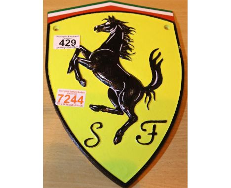 Cast iron Ferrari sign, L: 29 cm. P&amp;P Group 1 (£14+VAT for the first lot and £1+VAT for subsequent lots) 