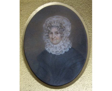 An oval half length portrait miniature, of a lady wearing a lace bonnet and collar, pencil, 12 x 9.5 cm