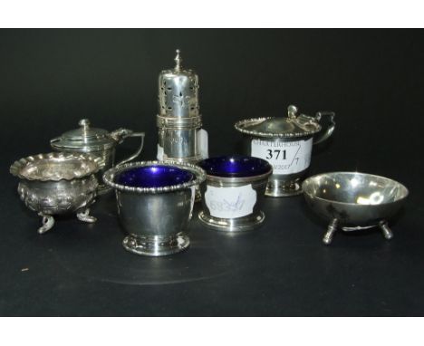 A Victorian silver sander, London 1895, 9.5 cm high, a silver mustard pot, with matching salt, two others, approx. 7.1 ozt, a