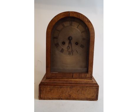 A mantel clock, the silver arched dial with Roman numerals, striking on a bell, in a maple case, 24.5 cm high   Condition rep